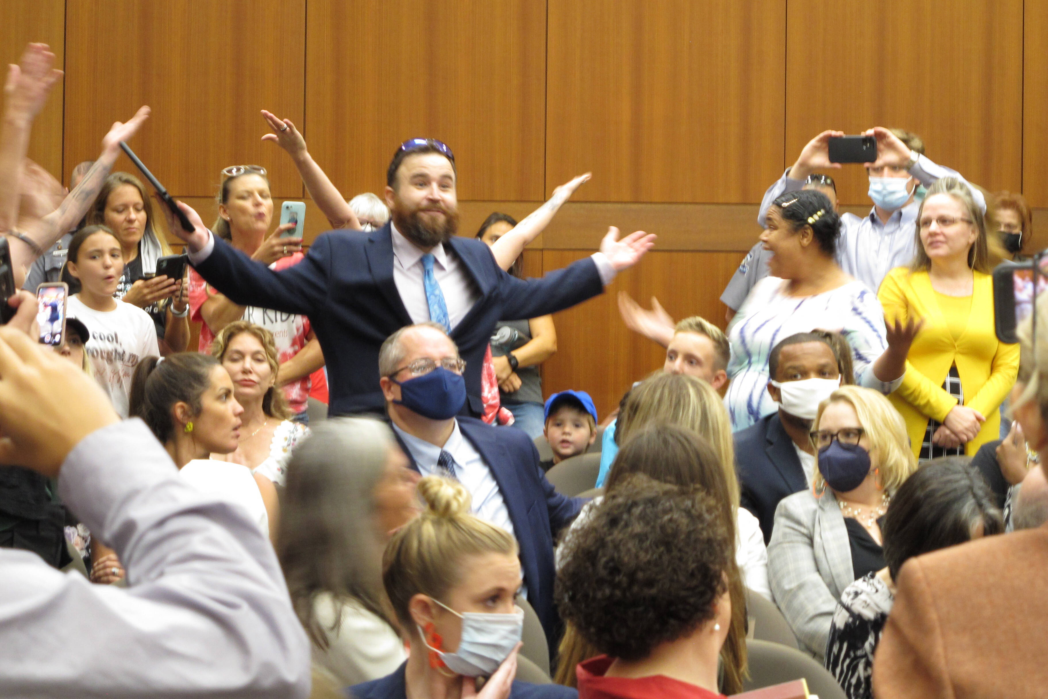 A crowd of angry, largely unmasked people objects to Louisiana Gov. John Bel Edwards's mask mandate for schools on Wednesday.
