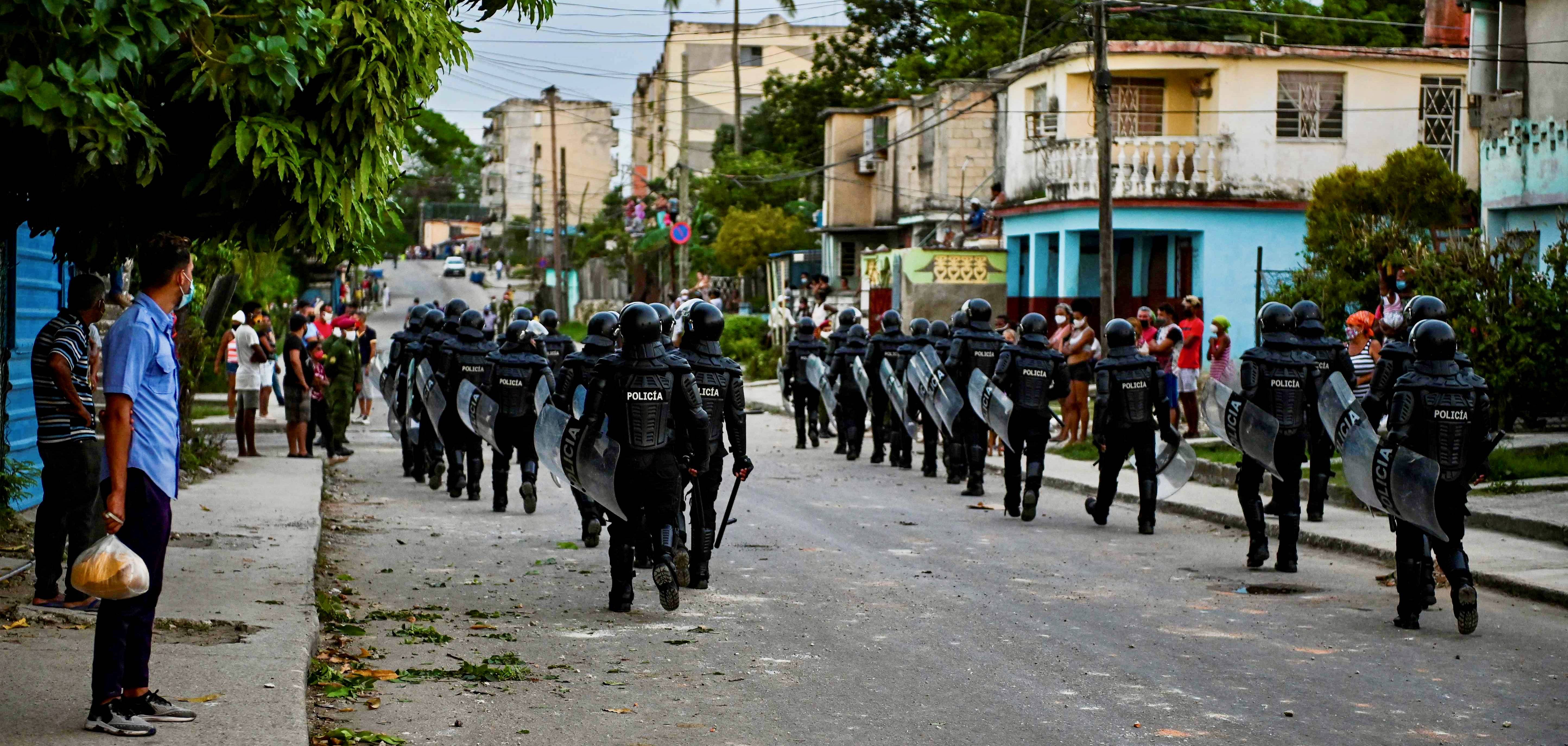 Riot police walk the streets after an anti-government demonstration on Monday in the Arroyo Naranjo section of Havana. (Yamil Lage/Agence France-Presse/Getty Images)&nbsp;
