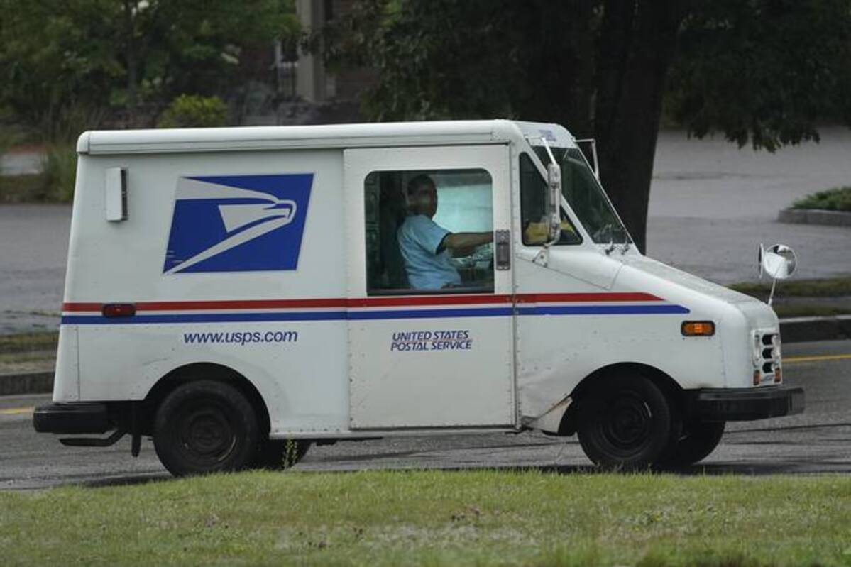Postal worker John Graham on the job last summer in Portland, Maine. (Robert F. Bukaty/AP)