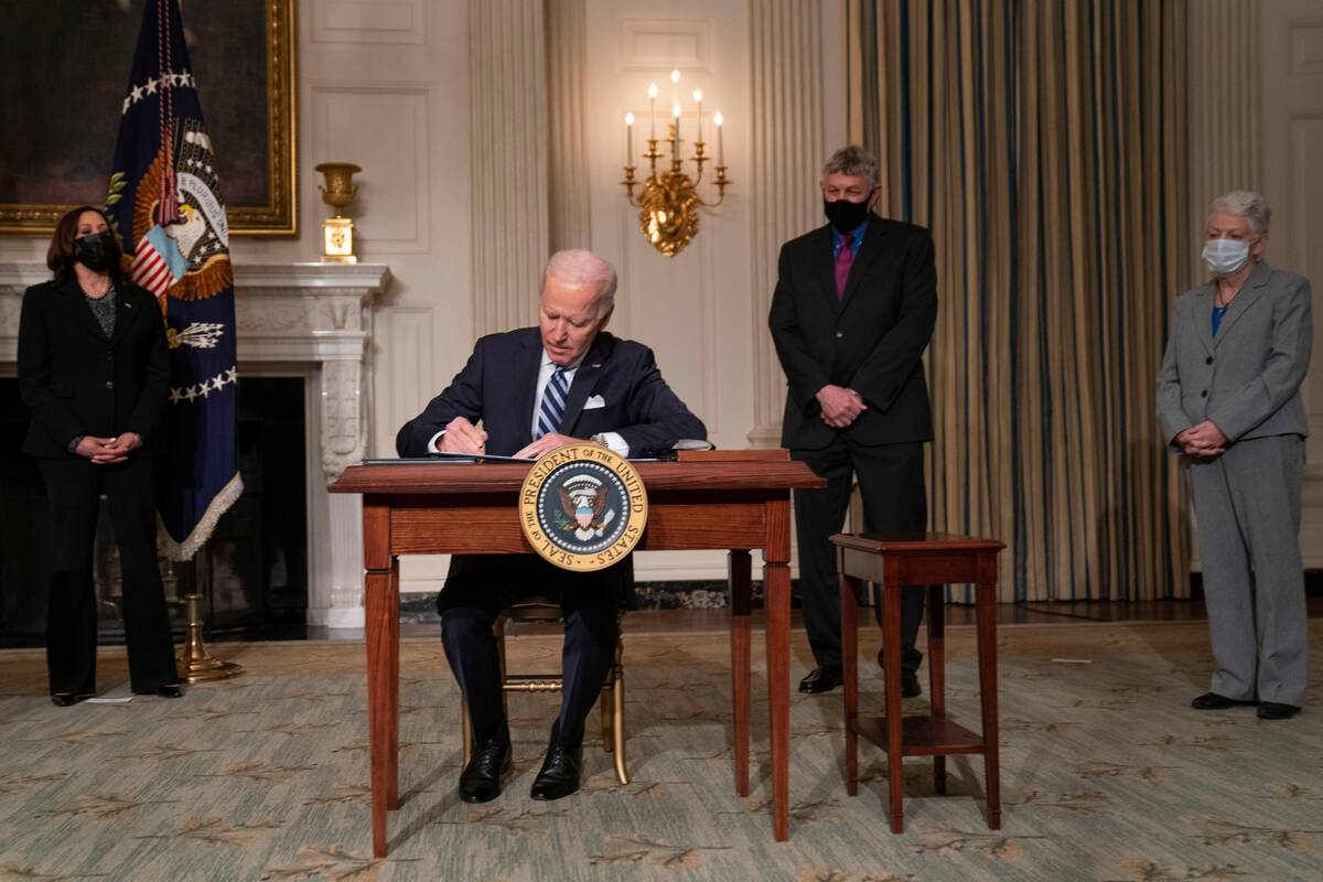 President Biden signs executive orders on climate change with Vice President Harris, White House science adviser Eric Lander and climate adviser Gina McCarthy on Jan. 27, 2021. (Evan Vucci/AP)