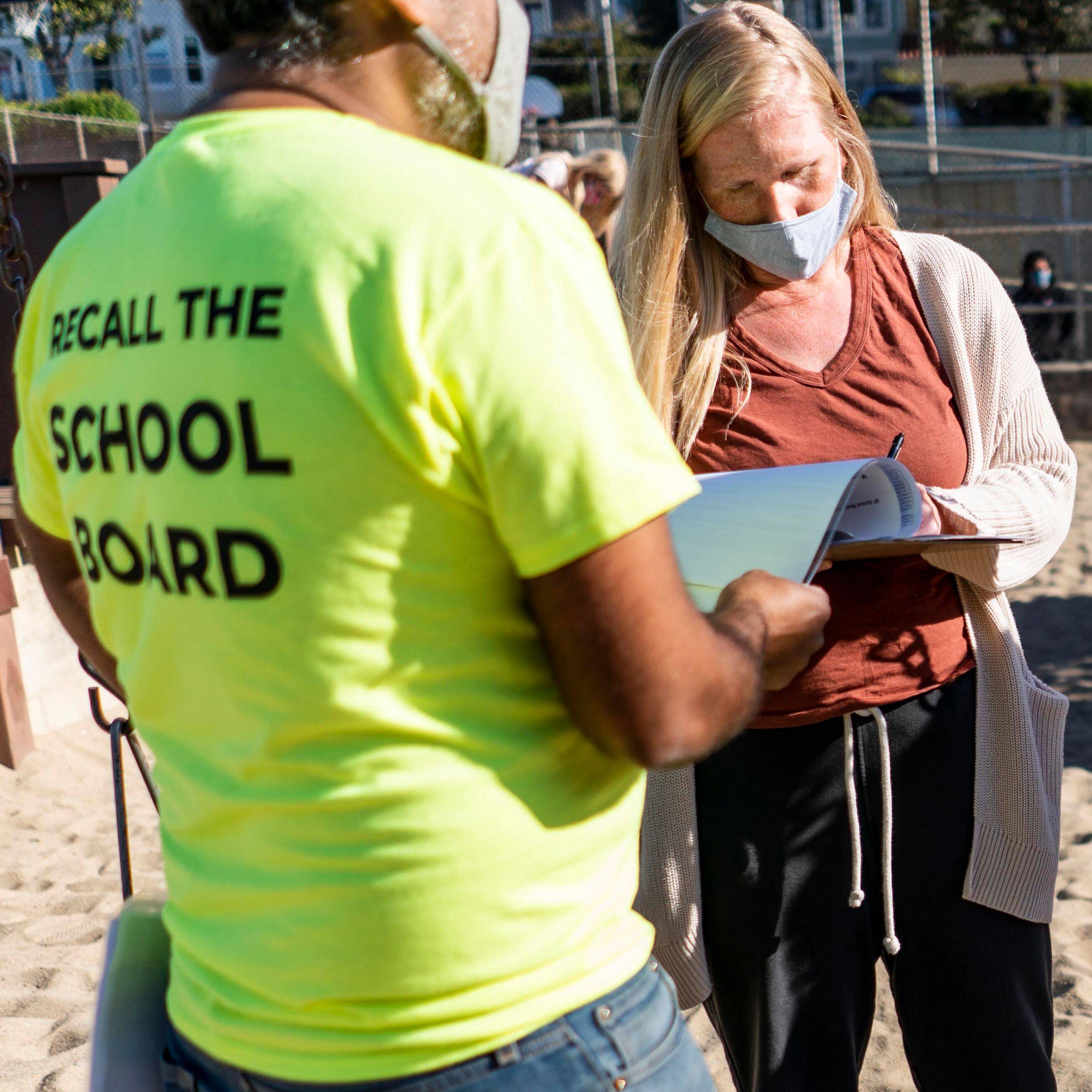 Siva Raj, a parent from the Recall SF School Board volunteer group, speaks to San Francisco residents at the Grattan playground about the recall of school board members, on April 15, 2021. (Melina Mara/The Washington Post)