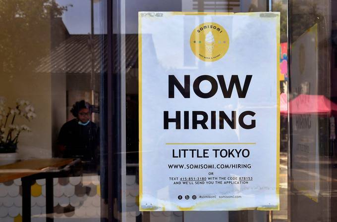 A 'Now Hiring' sign is posted in front of an ice cream shop in Los Angeles on May 28. (Frederic J. Brown/AFP/Getty Images)