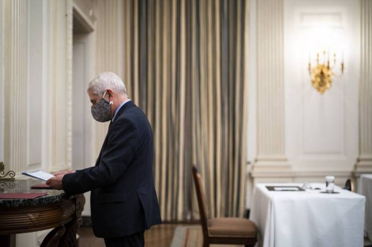 Anthony S. Fauci waits before President Biden arrives to speak about the coronavirus pandemic and sign executive orders in the State Dining Room at the White House. (Jabin Botsford/The Washington Post)