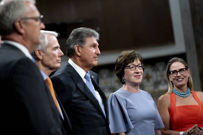 A bipartisan group of senators announce a tentative agreement on a $550 billion infrastructure package on Wednesday. Photographer: Stefani Reynolds/Bloomberg