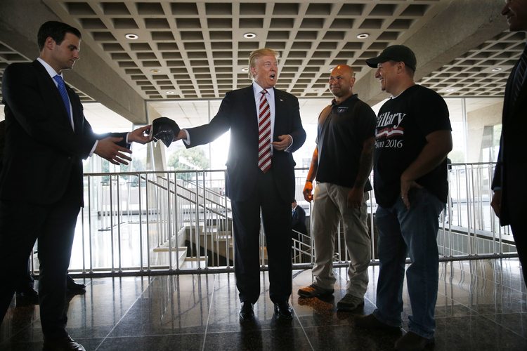 Trump chats with military veterans in Milwaukee. (AP/Gerald Herbert)</p>