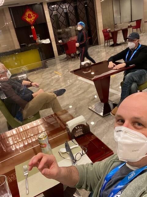 Post staffers Dave Sheinin (top), Dan Steinberg (bottom) and Barry Svrluga eating dinner at their Olympics hotel this week separated by plexiglass barriers. (Dan Steinberg)