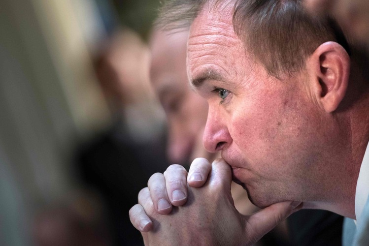 Office of Management and Budget Director Mick Mulvaney listens yesterday while Trump speaks at the Eisenhower Executive Office Building. (Brendan Smialowski/AFP/Getty Images)</p>  