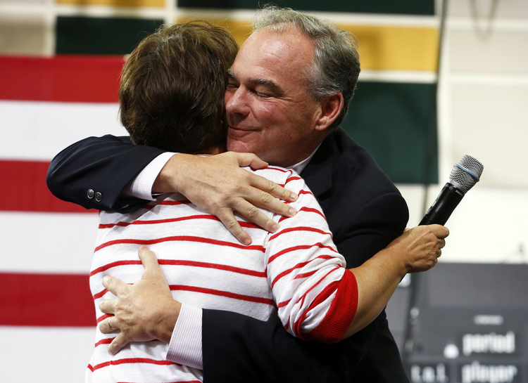 Sen. Tim Kaine, D-Va., gives his his wife Anne Holton a hug during a rally Monday in Richmond, Va. (AP Photo/Steve Helber)</p>