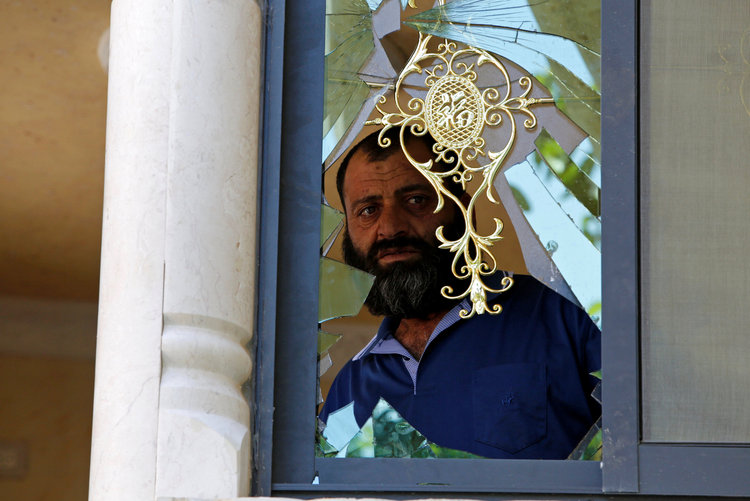 A man&nbsp;checks out the damage to the house of one of the Palestinian assailants who carried out a shooting attack in Tel Aviv after it was raided by Israeli forces, in Yatta near the West Bank city of Hebron.&nbsp;(Reuters/Mussa Qawasma)</p>  