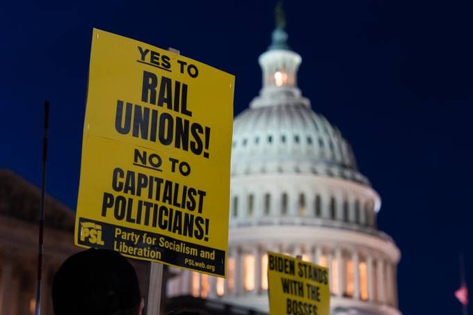 Protesters in support of unionized rail workers hold up signs outside the U.S. Capitol on Tuesday. (Elizabeth Frantz/The Washington Post)