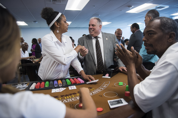 Larry Hogan greets workers yesterday at the MGM National Harbor Employment Center as they are trained on table games in Oxon Hill, Md.&nbsp;(Photo by Jabin Botsford/The Washington Post)</p>  