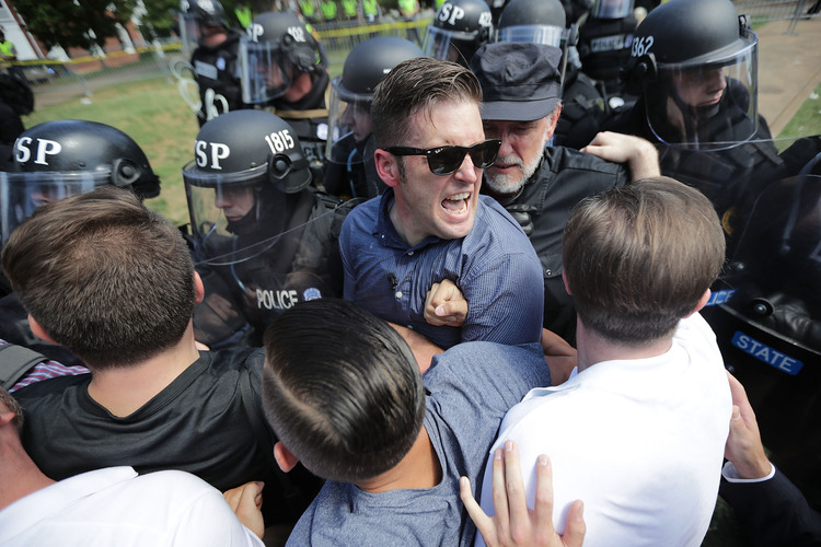 White nationalist Richard Spencer and his supporters clash with Virginia State Police in Lee Park after the "United the Right" rally was declared an unlawful gathering on Saturday in Charlottesville. (Chip Somodevilla/Getty Images)  