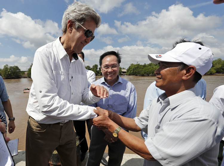 John Kerry&nbsp;shakes hands with a former Viet Cong guerrilla who took part in an ambush on his Swift Boat in 1969.&nbsp;(AP/Alex Brandon)</p>  
