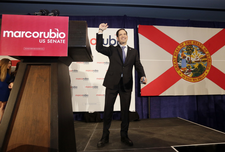 Florida Republican Sen. Marco Rubio acknowledges the cheers from supporters after winning a second term in office. (AP Photo/Wilfredo Lee)</p>  