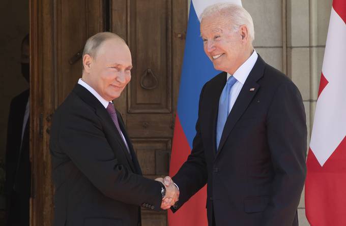President Biden and Russian President Vladimir Putin shake hands as they meet in Geneva on Wednesday. (Saul Loeb/AP)