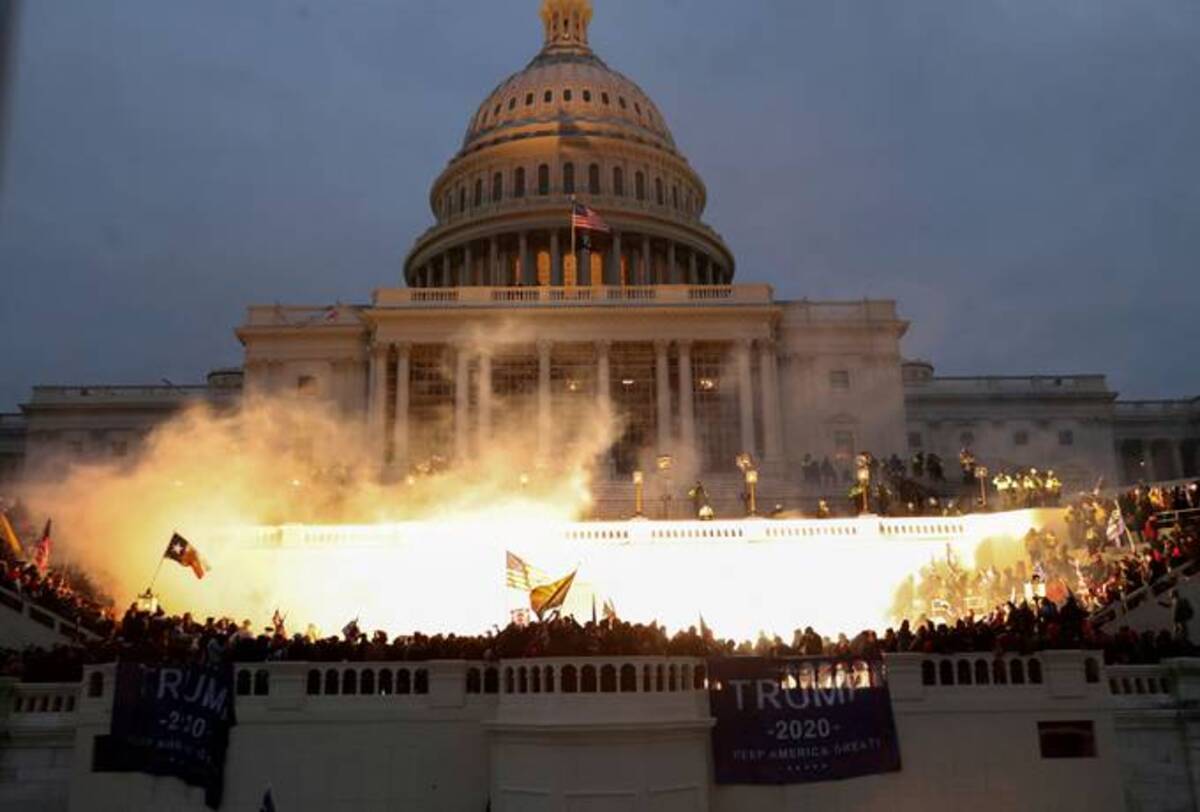An explosion caused by a police munition is seen while supporters of President Donald Trump gather in front of the U.S. Capitol on Jan. 6, 2021. (Leah Millis/Reuters)