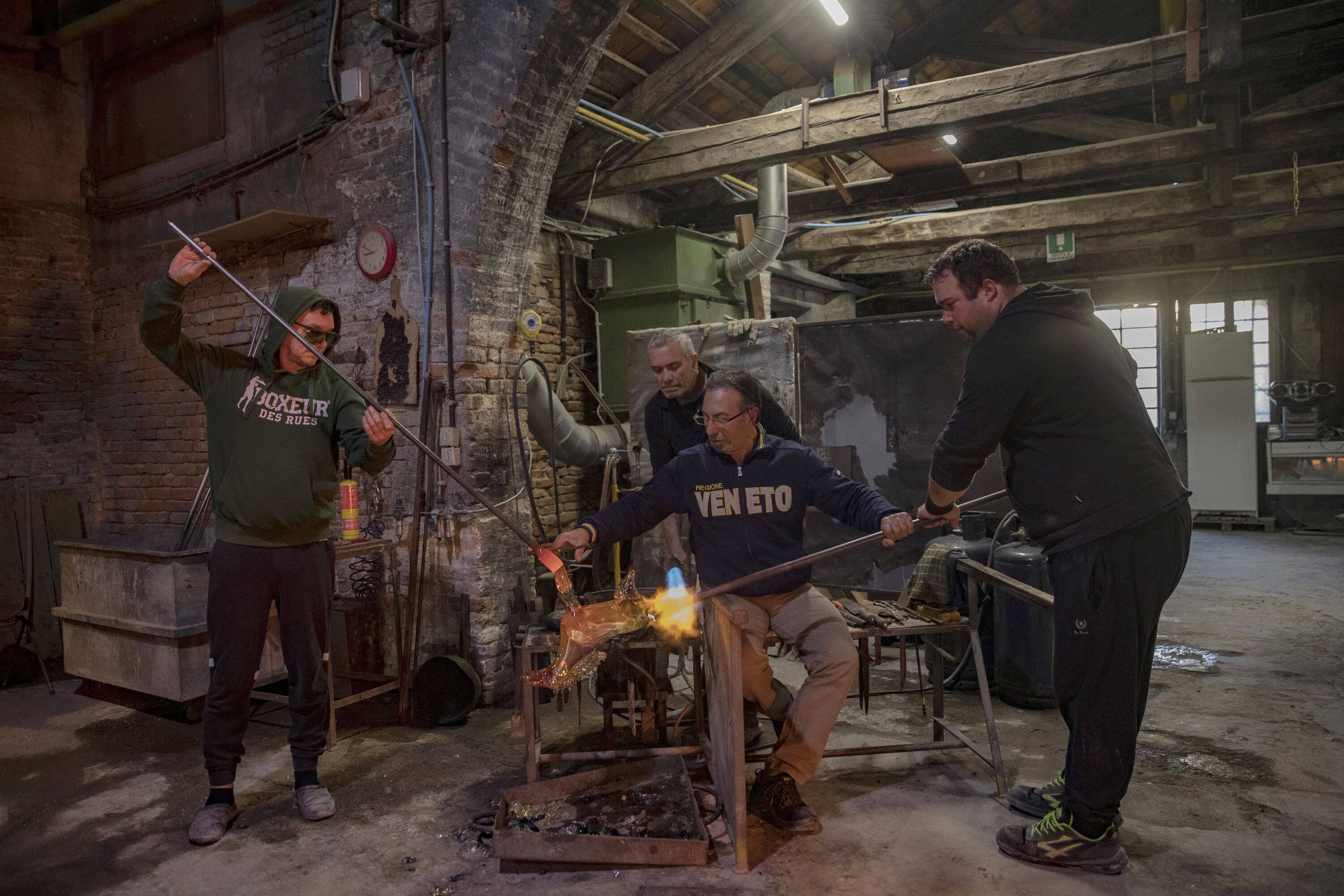 Oscar Zanetti, his son Andrea Zanetti and other artists at the Zanetti glass factory in Murano, Italy, on Dec.17. (Francesca Volpi for The Washington Post)