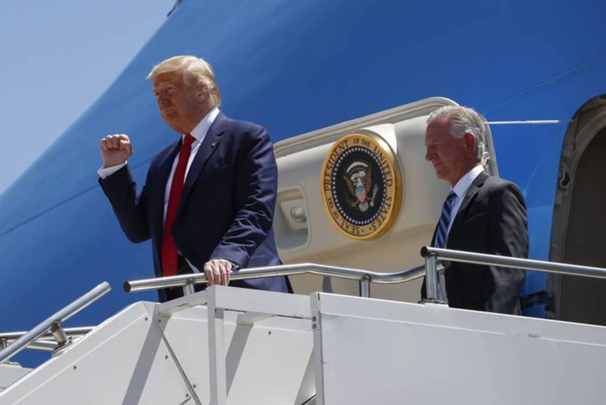 In this June 11, 2020, photo President Donald Trump gestures as he steps off Air Force One at Dallas Love Field in Dallas with Senate candidate Tommy Tuberville of Alabama. (Alex Brandon/AP)