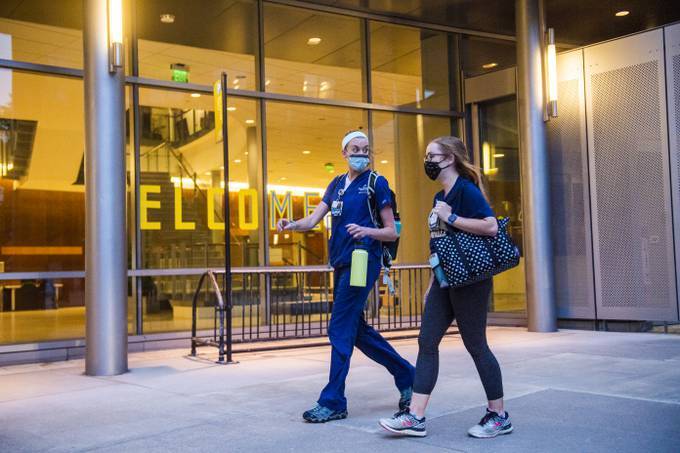 Workers exit Johns Hopkins Hospital in Baltimore. (Amanda Voisard/The Washington Post)