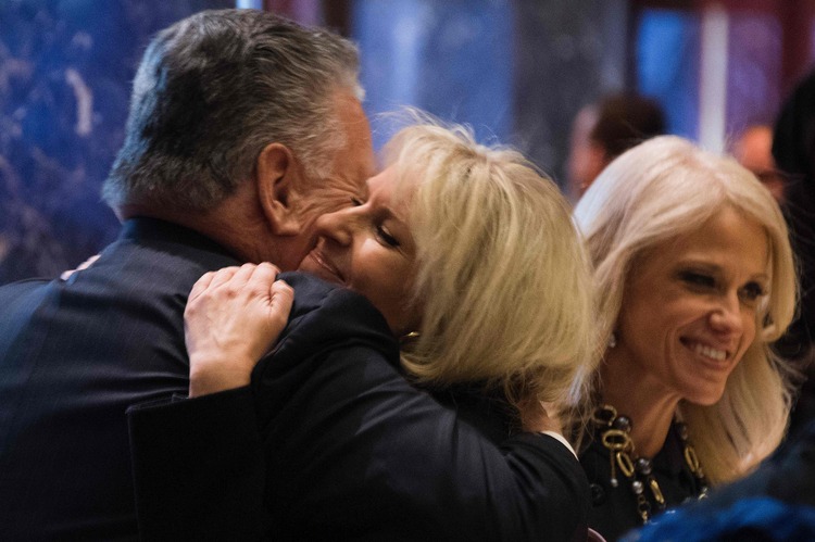 Monica Crowley, a Fox News analyst about to get one of the most important jobs in the White House, hugs Rep. Peter King (R-NY) in the lobby of Trump Tower. (Jim Watson/AFP/Getty Images)</p>  