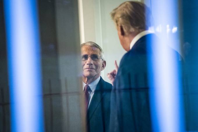 President Donald Trump speaks with infectious-disease expert Anthony S. Fauci after a briefing from the coronavirus task force in April last year. (Jabin Botsford/The Washington Post)