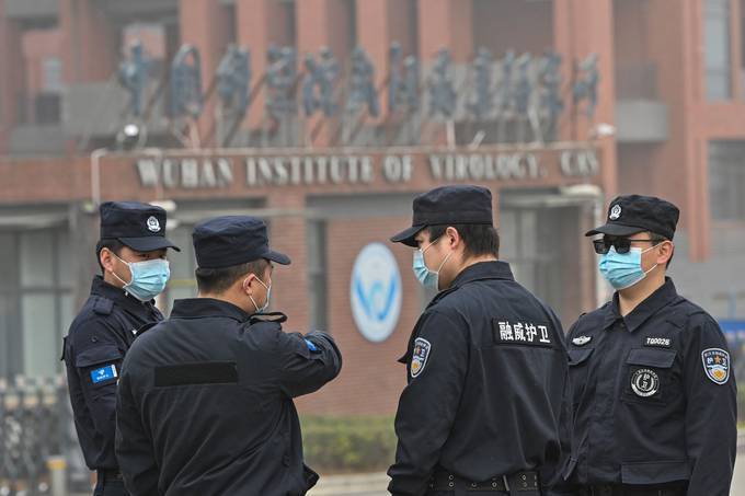 Security personnel stand guard outside the Wuhan Institute of Virology. (Hector Retamal/AFP/Getty Images)