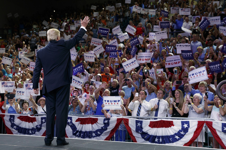 Donald Trump waves to the crowd as he arrives for a rally at the University of North Carolina in Wilmington yesterday.&nbsp;(Evan Vucci/AP)</p>  