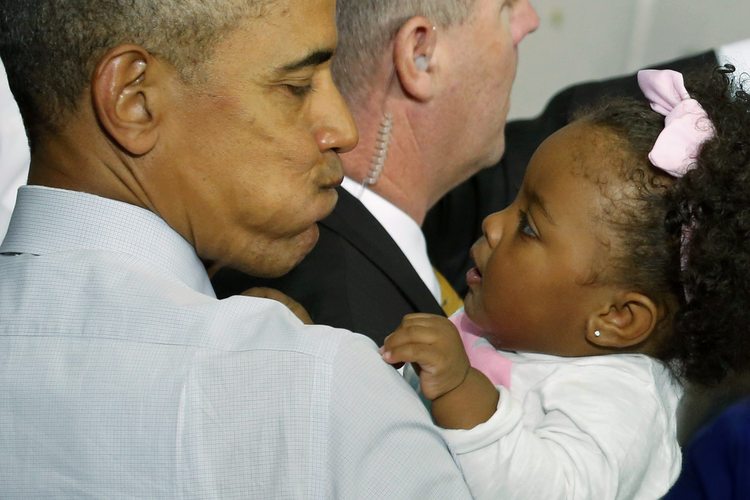 President Obama puffs out his cheeks at a baby after his speech in Fayetteville. (Jonathan Ernst/Reuters)</p>  