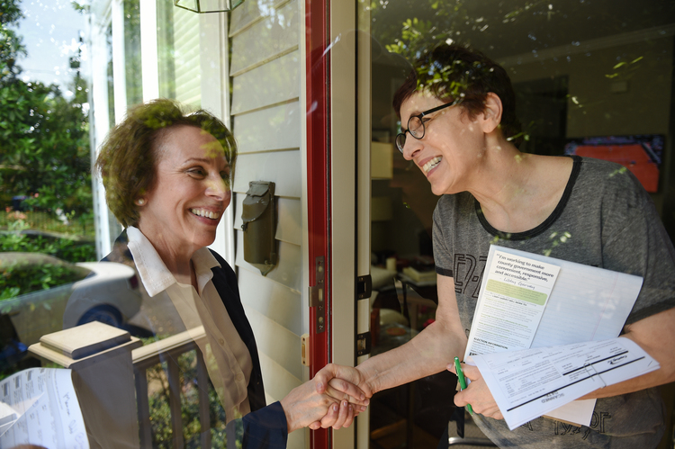 Libby Garvey (L), chair of the Arlington County Board, door knocks. (Photo by Astrid Riecken For The Washington Post)</p>  