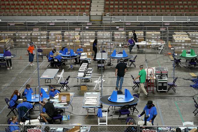 Maricopa County ballots are reviewed at Veterans Memorial Coliseum in Phoenix. (Matt York/Pool/AP)