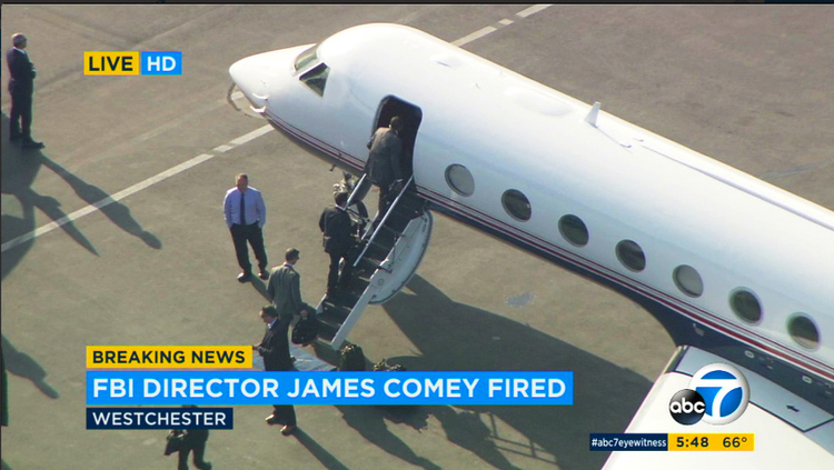 James Comey boards a private jet at Los Angeles International Airport last night after Donald Trump fired him as FBI director. He learned the news on television. (KABC-TV via AP)</p>  