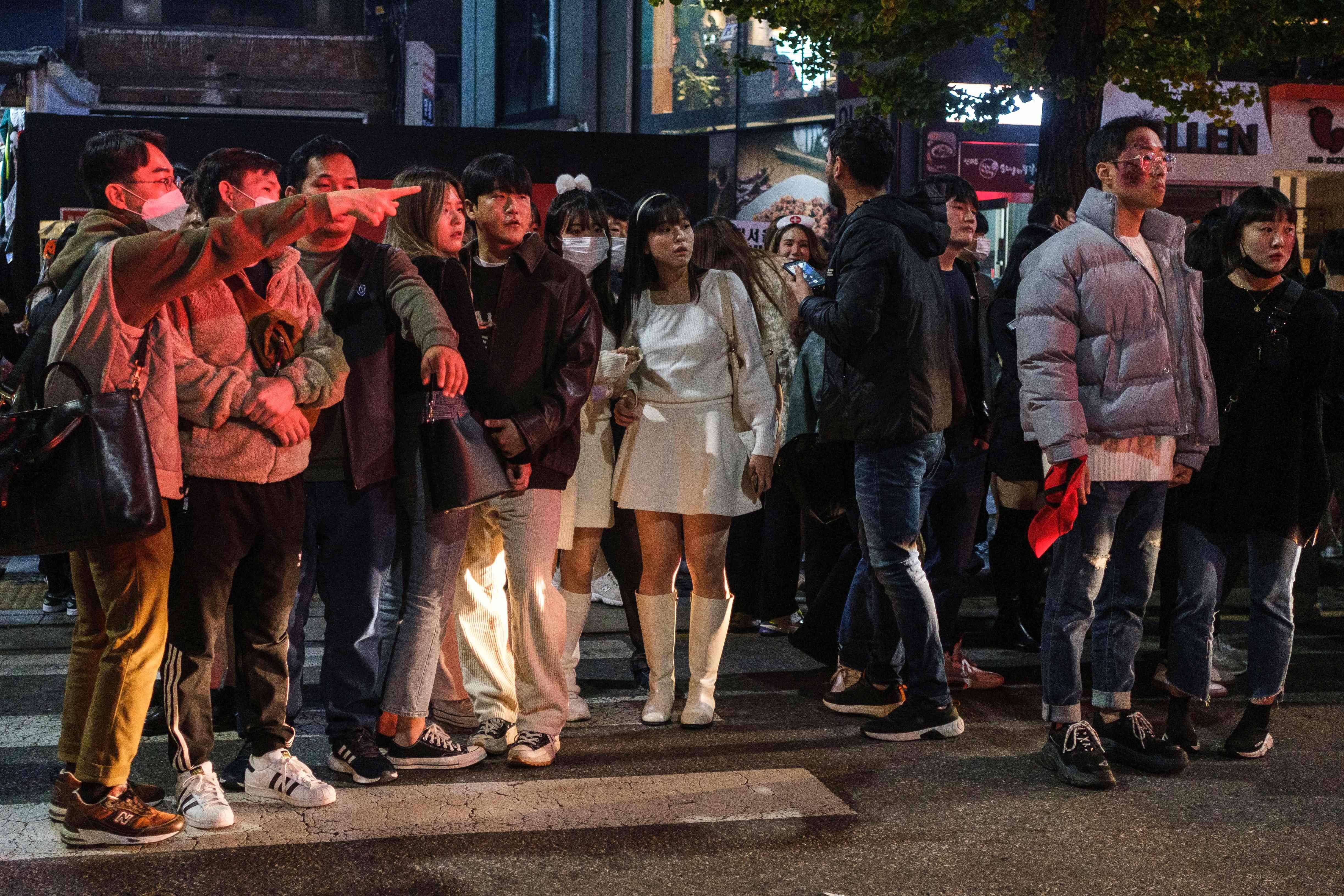 People watching after the Halloween crowd crush in Seoul. (Albert Retief/AFP via Getty Images)