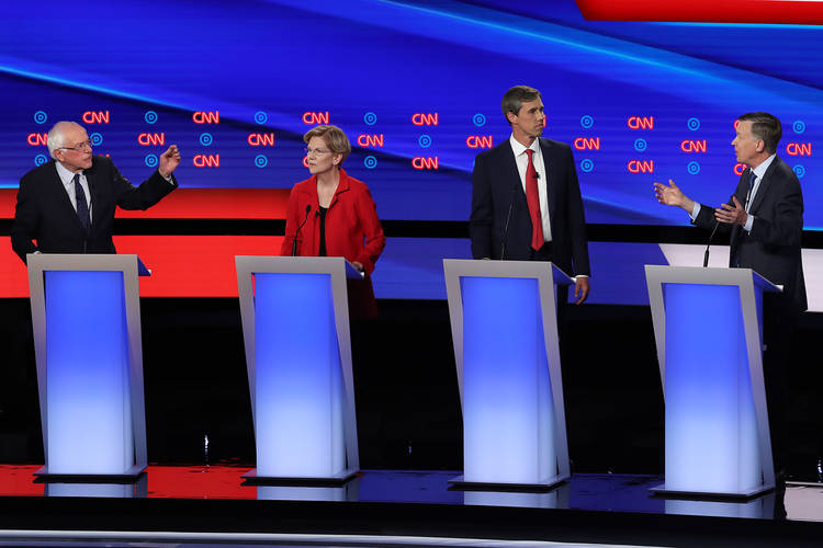 Bernie Sanders and John Hickenlooper argue while Elizabeth Warren and Beto O'Rourke listen. (Justin Sullivan/Getty Images)  
