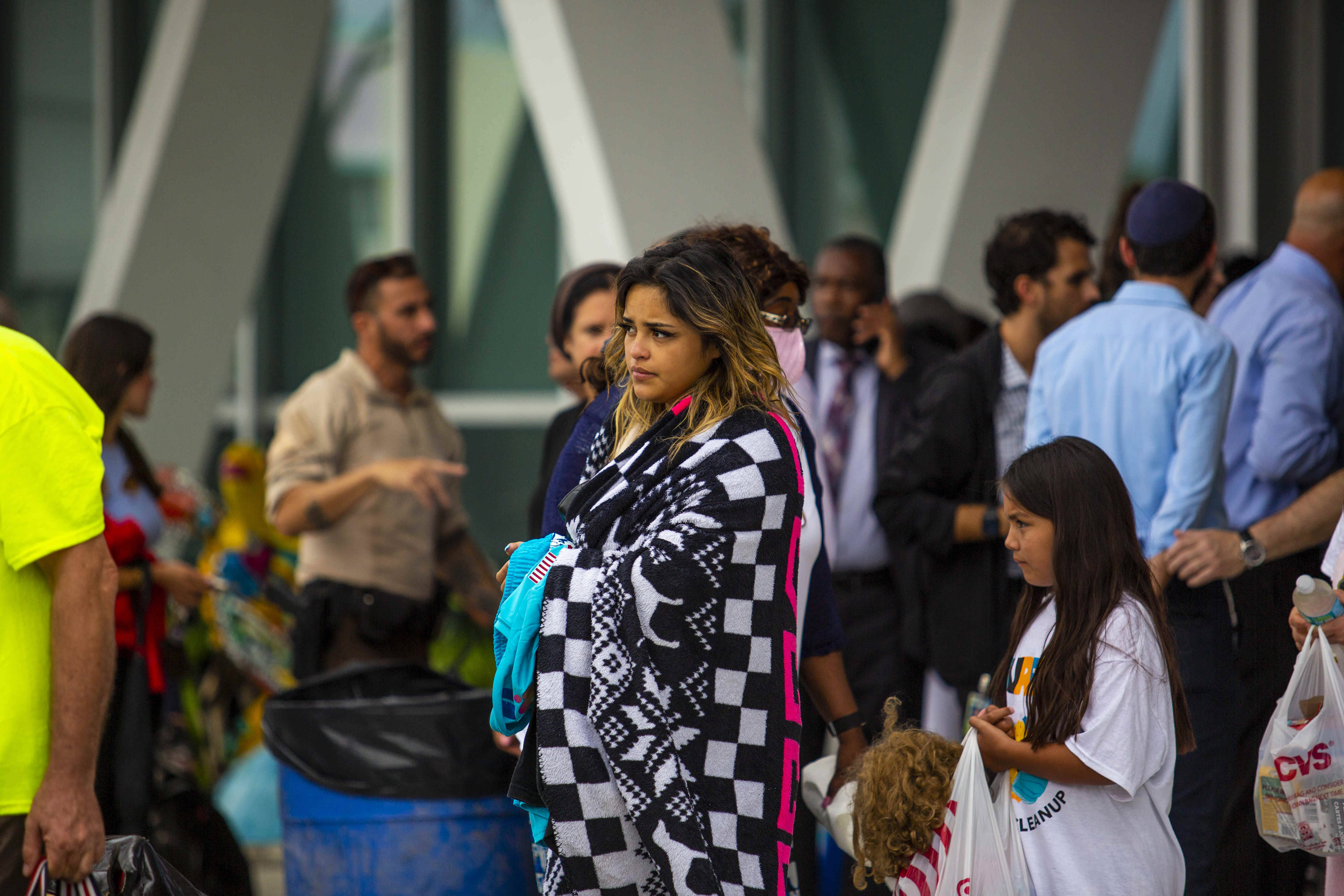 People who were forced to evacuate the surrounding buildings after a 12-story condo tower partially collapsed in Surfside, Fla., on Thursday. (Saul Martinez/The Washington Post)