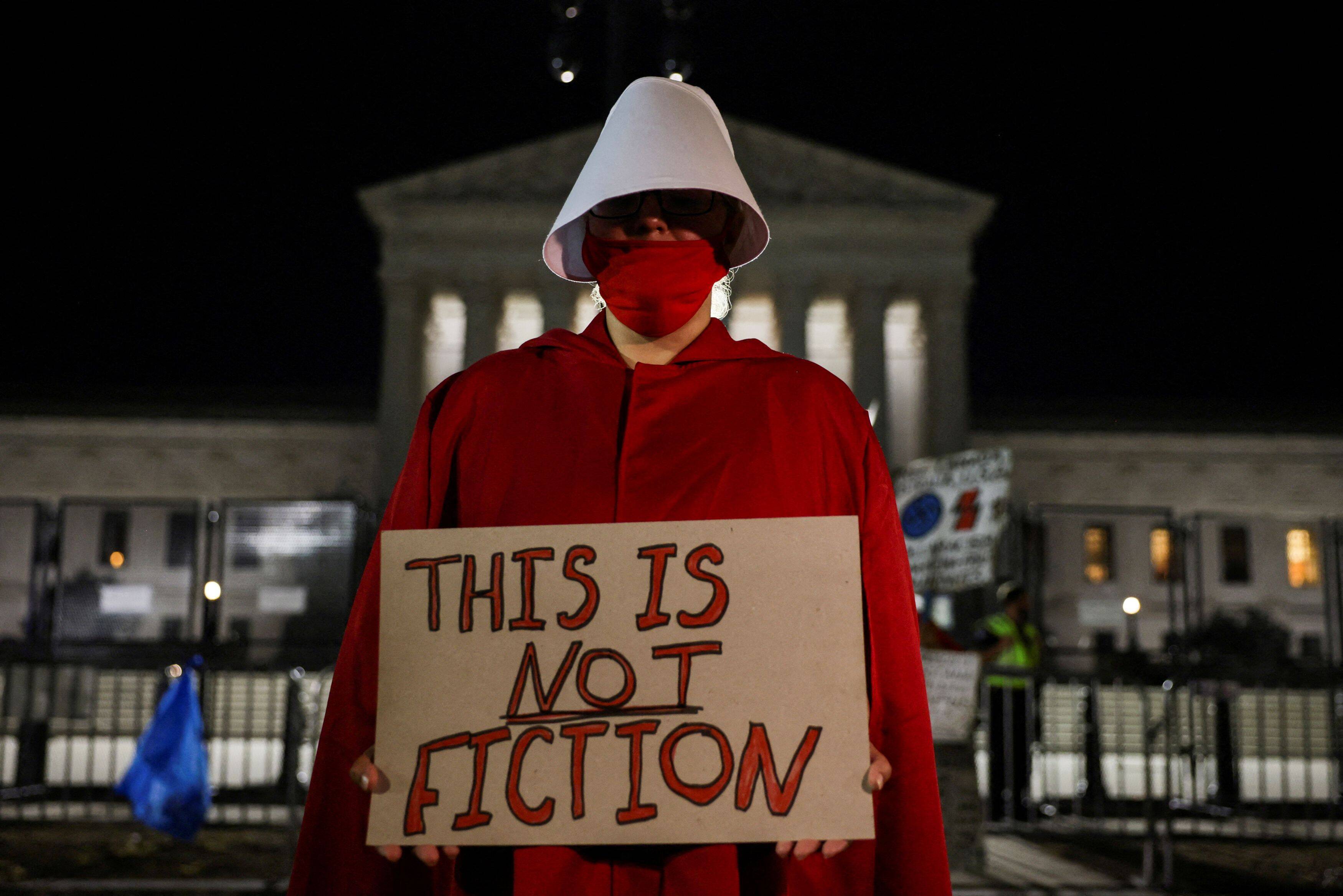 An abortion rights demonstrator, dressed in a 