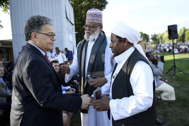 Sen. Al Franken (D-Minn.) shakes hands with Sa'ad Musse Roble, center, with the World Peace Organization, and Omer Andi Nur, visiting from Michigan, after Franken spoke at a rally at Dar Al-Farooq Islamic Center in Bloomington, Minn. The suburban Minneapolis mosque was bombed Aug. 5 as worshippers were about to start their morning prayers. No one was hurt. (Aaron Lavinsky/Star Tribune via AP)  
