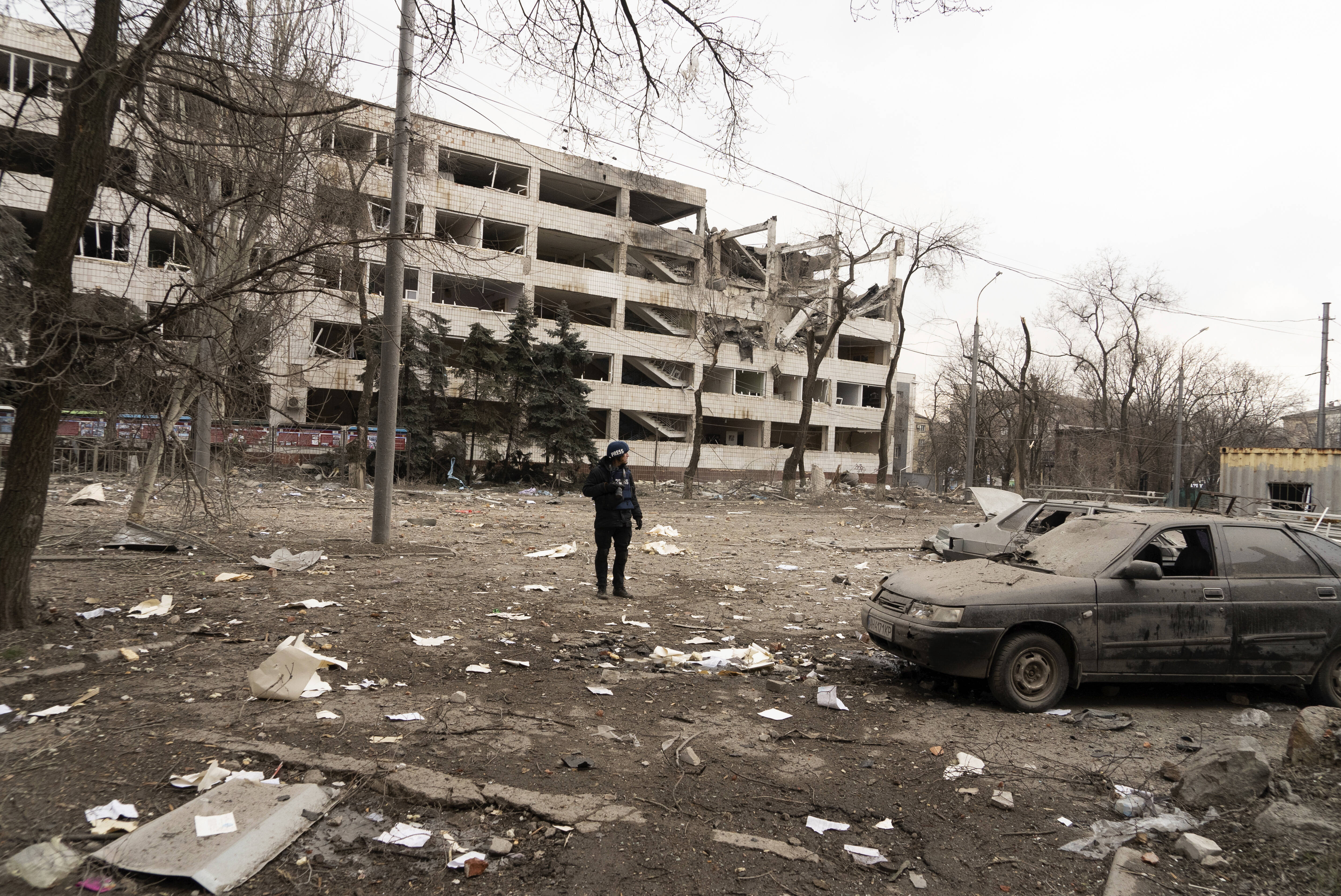 Associated Press photographer Evgeniy Maloletka stands amid rubble of an airstrike on Pryazovskyi State Technical University on March 10 in Mariupol, Ukraine. (Mstyslav Chernov/AP)