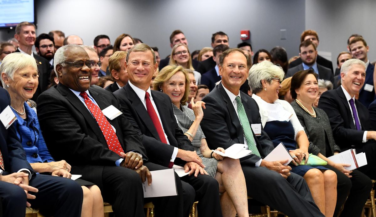 From left, Maureen Scalia, with Supreme Court Justice Clarence Thomas, Chief Justice John G. Roberts, his wife Jane Sullivan Roberts, Justice Samuel Alito and his wife Martha Bomgardner, Justice Elena Kagan and Justice Neil Gorsuch attend George Mason University's Antonin Scalia Law School dedication of a statue of the late Supreme Court justice on Oct. 4, 2018, in Arlington, Va (Katherine Frey/The Washington Post)