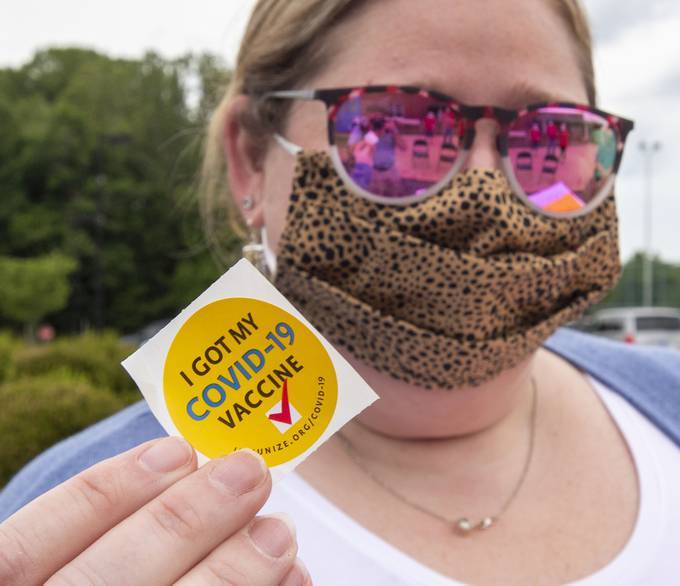 Lorie Stevens shows her "COVID-19 Vaccine" sticker after getting her shot at the VDH vaccination clinic in Abingdon, Va. (David Crigger/Bristol Herald Courier via AP)