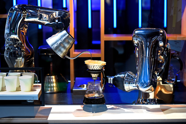 Robotic arms make coffee in a demonstration using a pair of VS-S2 Series robots at the Denso booth at CES 2017 in Las Vegas. (David Becker/Getty Images)</p>