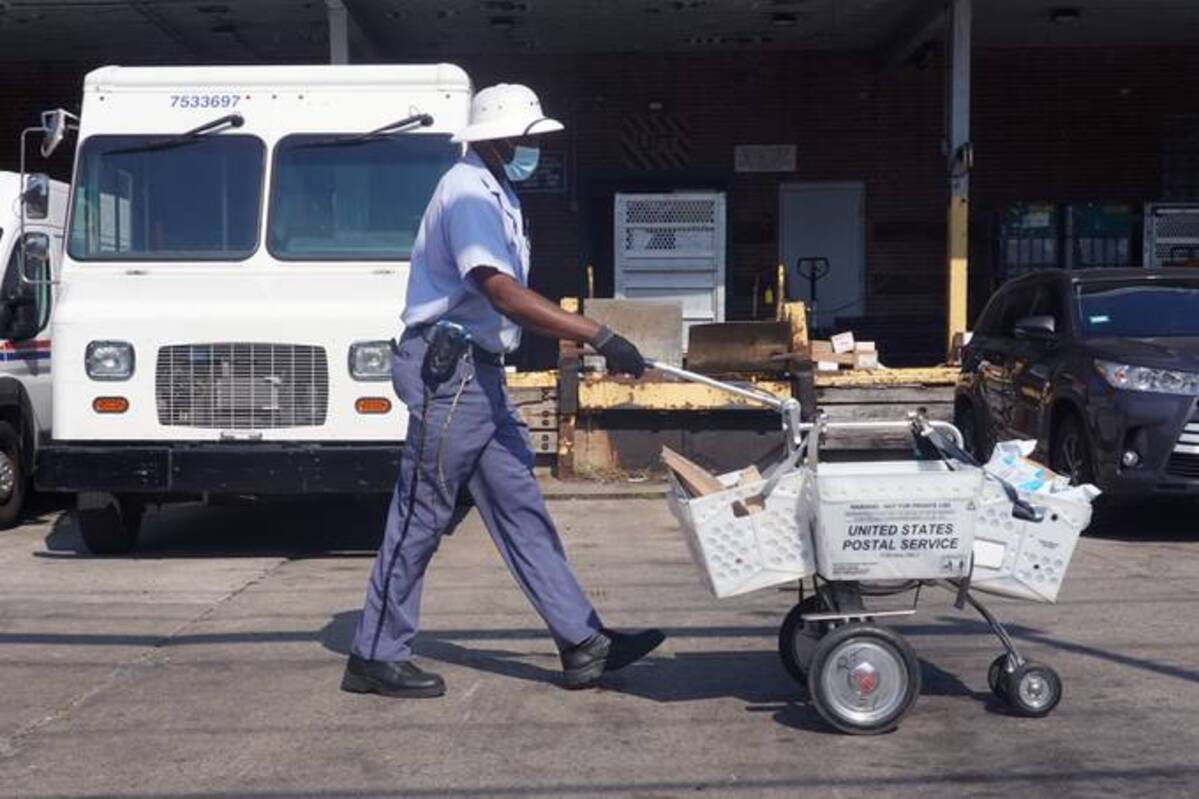 A postal worker heads out on his route on Oct. 01, 2021 in Chicago. (Scott Olson/Getty Images)