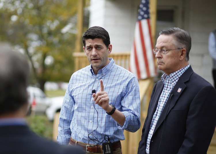 Paul Ryan, talks with Rep. Rod Blum outside a Catholic hospitality house in Iowa. (Matthew Putney/AP)</p>  