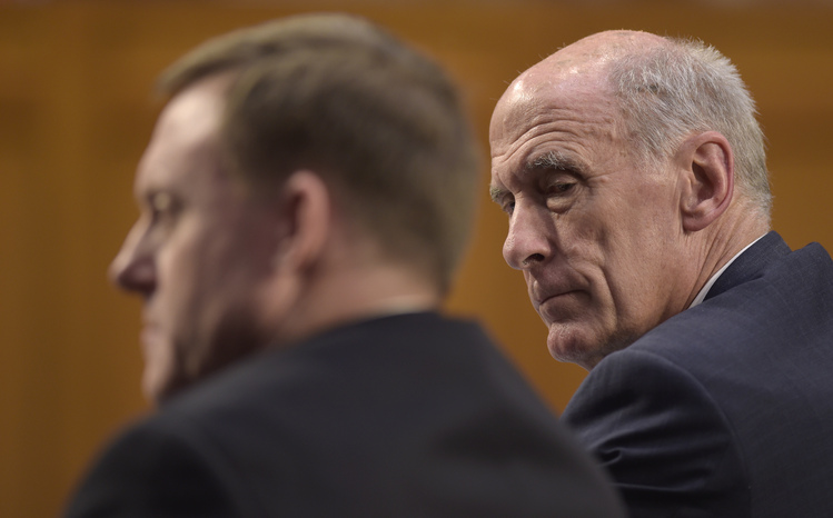 Dan Coats, right, listens last week as Mike Rogers is questioned during a Senate Intelligence Committee hearing. (Susan Walsh/AP)</p>  