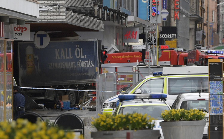 The rear of a truck protrudes after it crashed into a department store in Stockholm. (Anders Wiklund/TT News Agency via AP)</p>  