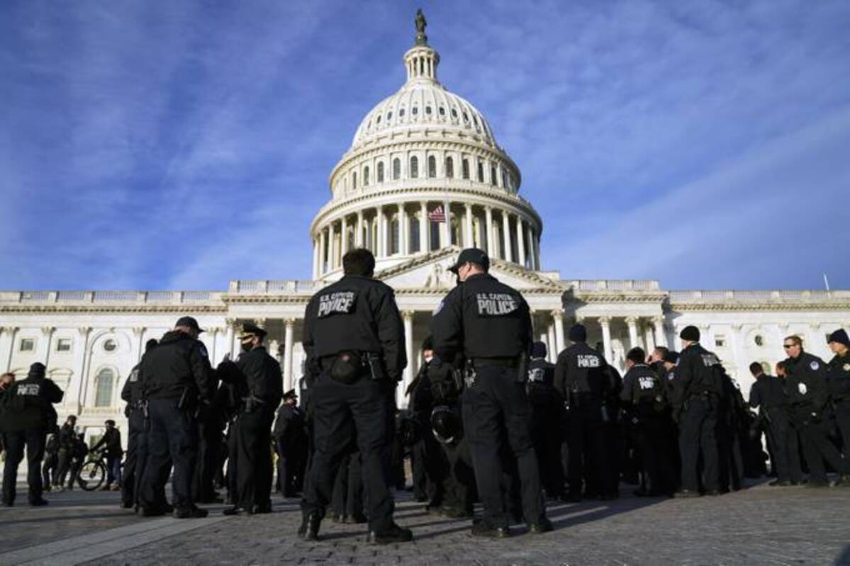 A large group of police arrive at the Capitol in Washington, Thursday, Jan. 6, 2022. (Evan Vucci/AP)