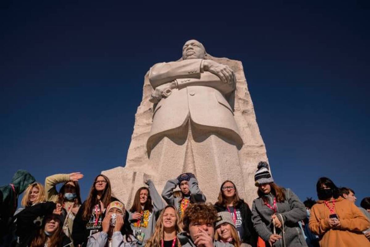 A group of ninth grade students from Iowa takes group photos in front of the Martin Luther King, Jr. Memorial during their field trip to Washington, D.C. (Shuran Huang for The Washington Post)