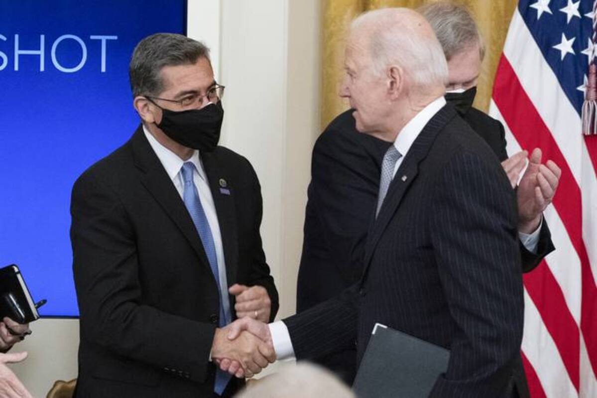 Health and Human Services Secretary Xavier Becerra shakes hands with President Biden. (Alex Brandon/AP)