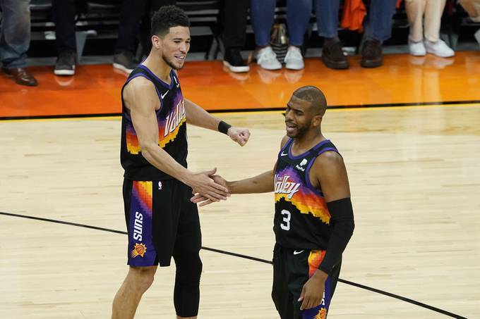 Chris Paul and Devin Booker led the Phoenix Suns to a convincing first-round win over the Los Angeles Lakers. (Matt York/AP)