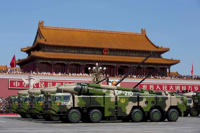 In this Sept. 3, 2015, file photo, Chinese military vehicles carrying DF-21D anti-ship ballistic missiles pass by Tiananmen Gate during a military parade to commemorate the 70th anniversary of the end of World War II, in Beijing. (Andy Wong/AP File)