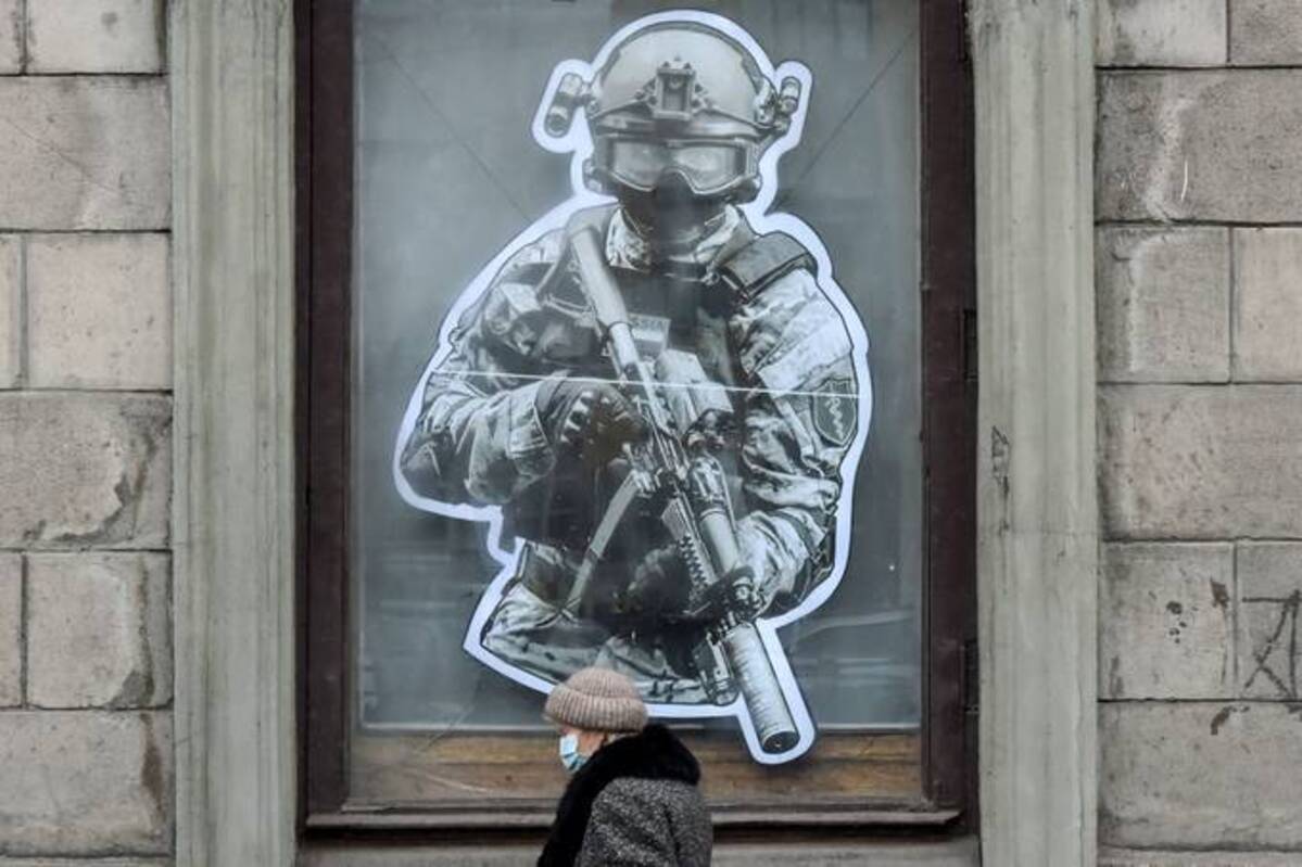 A woman walks past a military store in St. Petersburg on Friday. (AFP)&nbsp;
